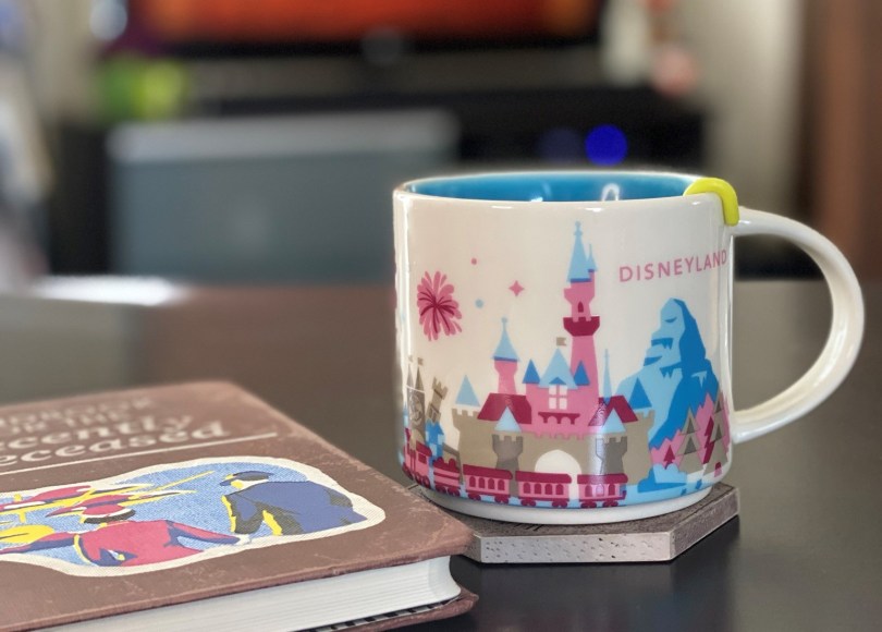 beetlejuice "handbook for the recently deceased" journal and a Disneyland mug,
